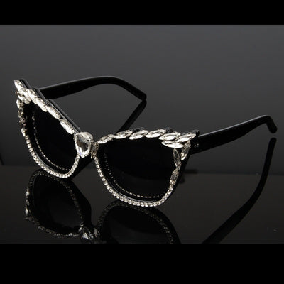 Black cat-eye sunglasses with clear rhinestones along the frames and a large teardrop rhinestone at the bridge. - Image 5