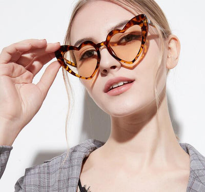 Heart-shaped tortoiseshell sunglasses with light brown lenses on a white background, perfect for women. - Image 8