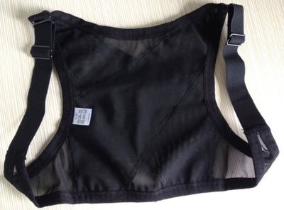 Woman wearing a black posture correction belt with criss-cross back design over a grey shirt, adjusting the strap. - Image 4