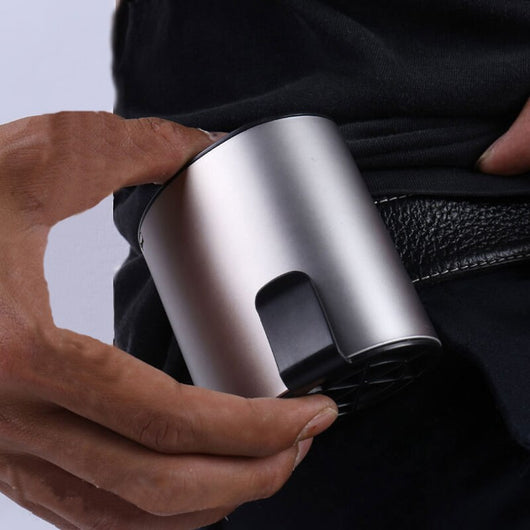 Close-up of a finger pressing the power button on a silver-grey portable waist fan with a black fan grill. - Image 11