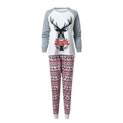 Young boy wearing a Christmas pajama set with a white and grey raglan top featuring a reindeer and fair isle print pants. - Image 11