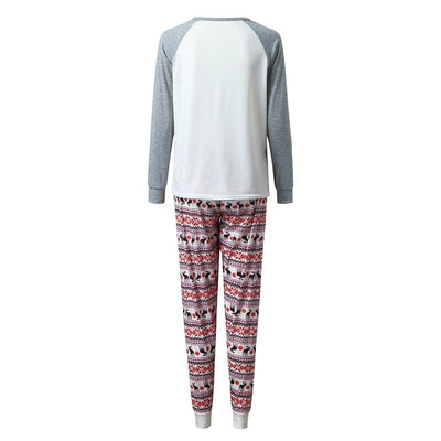 Young boy wearing a Christmas pajama set with a white and grey raglan top featuring a reindeer and fair isle print pants. - Image 12
