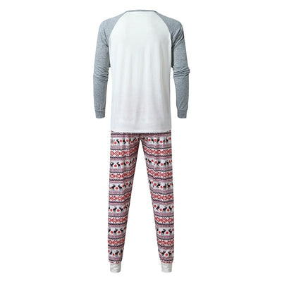 Young boy wearing a Christmas pajama set with a white and grey raglan top featuring a reindeer and fair isle print pants. - Image 15