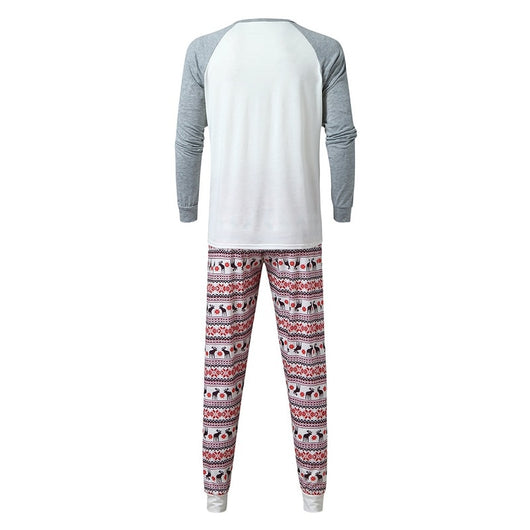 Young boy wearing a Christmas pajama set with a white and grey raglan top featuring a reindeer and fair isle print pants. - Image 15