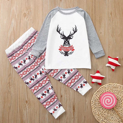 Young boy wearing a Christmas pajama set with a white and grey raglan top featuring a reindeer and fair isle print pants. - Image 18
