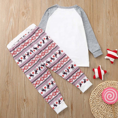 Young boy wearing a Christmas pajama set with a white and grey raglan top featuring a reindeer and fair isle print pants. - Image 19