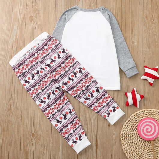 Young boy wearing a Christmas pajama set with a white and grey raglan top featuring a reindeer and fair isle print pants. - Image 19