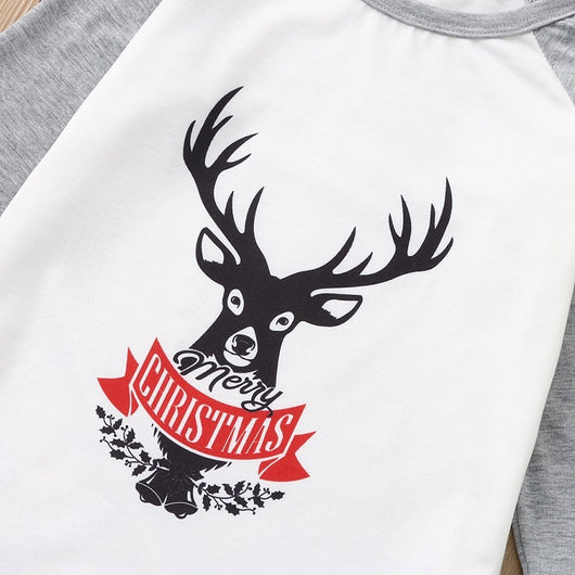 Young boy wearing a Christmas pajama set with a white and grey raglan top featuring a reindeer and fair isle print pants. - Image 20