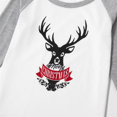 Young boy wearing a Christmas pajama set with a white and grey raglan top featuring a reindeer and fair isle print pants. - Image 25