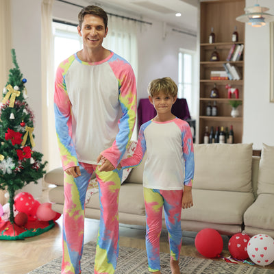 Family of four wearing matching pink, blue, and yellow tie-dye long-sleeved pajama sets in a living room. - Image 15