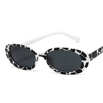Small frame oval sunglasses with a tortoiseshell pattern and brown lenses on a white background. - Image 3