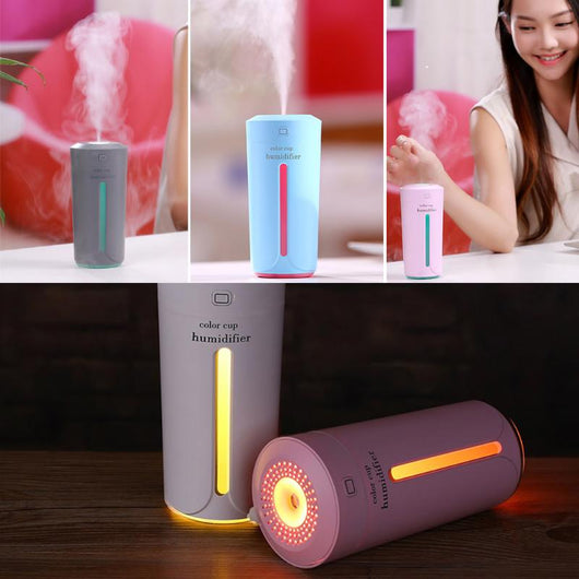 White mini USB ultrasonic humidifier with a green LED light strip, emitting mist, on a white surface. - Image 11