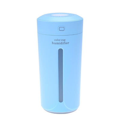 White mini USB ultrasonic humidifier with a green LED light strip, emitting mist, on a white surface. - Image 25