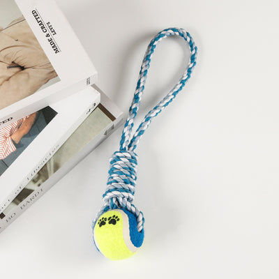 Red, pink, and white braided cotton rope dog toy with a green and red tennis ball featuring black paw prints. - Image 8