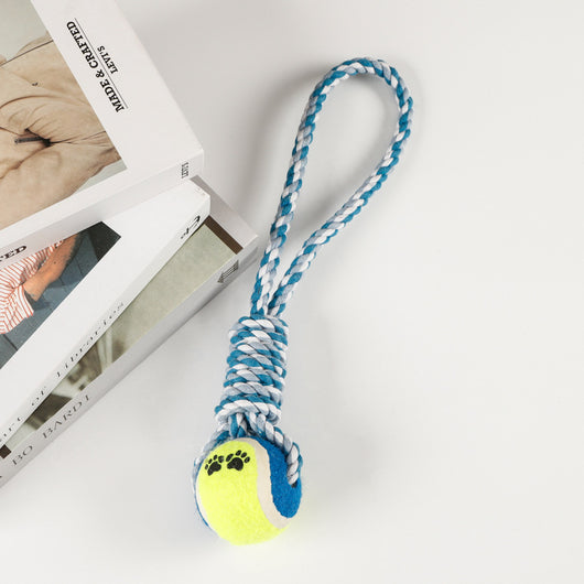 Red, pink, and white braided cotton rope dog toy with a green and red tennis ball featuring black paw prints. - Image 8