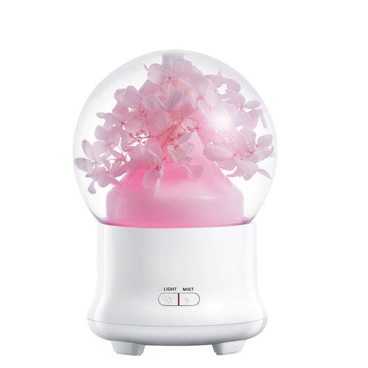 White aromatherapy machine with a clear dome top, featuring blue preserved flowers and an aqua glow. Includes 'LIGHT' and 'MIST' controls. - Image 11