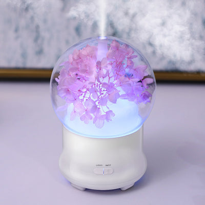 White aromatherapy machine with a clear dome top, featuring blue preserved flowers and an aqua glow. Includes 'LIGHT' and 'MIST' controls. - Image 14
