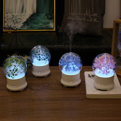 White aromatherapy machine with a clear dome top, featuring blue preserved flowers and an aqua glow. Includes 'LIGHT' and 'MIST' controls. - Image 15