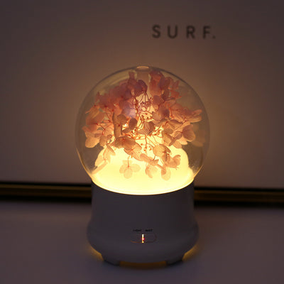 White aromatherapy machine with a clear dome top, featuring blue preserved flowers and an aqua glow. Includes 'LIGHT' and 'MIST' controls. - Image 16