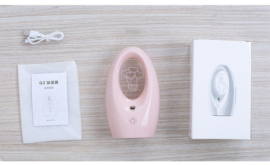 Navy blue USB humidifier with an oval shape and an illuminated castle design in the center. - Image 8