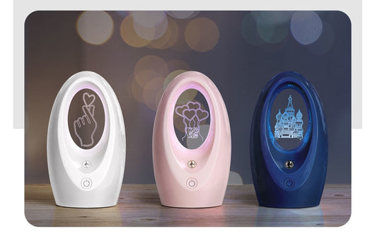 Navy blue USB humidifier with an oval shape and an illuminated castle design in the center. - Image 11