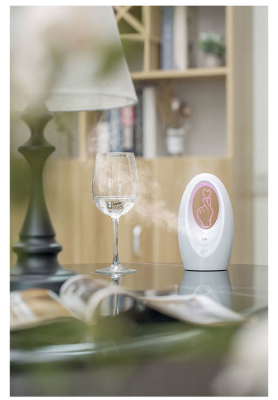 Navy blue USB humidifier with an oval shape and an illuminated castle design in the center. - Image 12