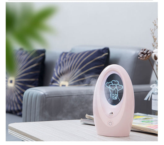 Navy blue USB humidifier with an oval shape and an illuminated castle design in the center. - Image 14
