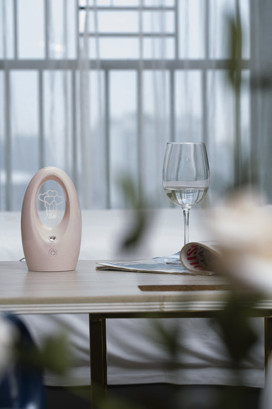Navy blue USB humidifier with an oval shape and an illuminated castle design in the center. - Image 22