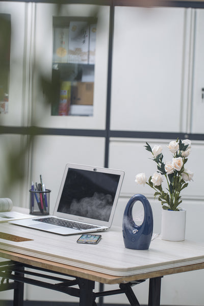Navy blue USB humidifier with an oval shape and an illuminated castle design in the center. - Image 23