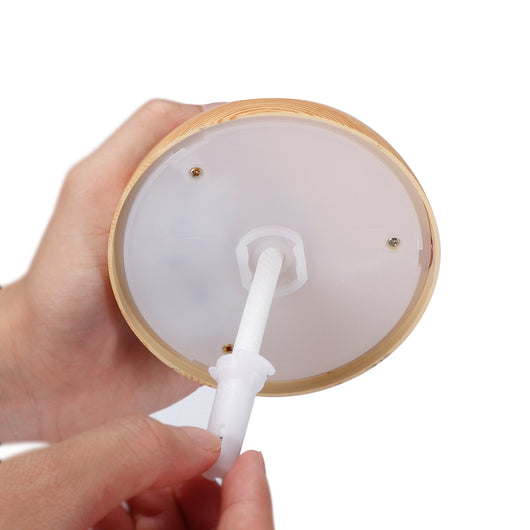 Dark wood grain mini ultrasonic humidifier with a mushroom shape and decorative hollow-out pattern. - Image 11