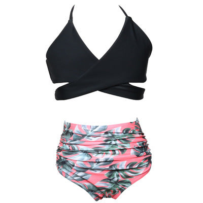 Black wrap bikini top with high-waisted pink and green tropical leaf print swim bottoms. - Image 30
