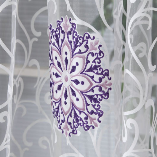 Sheer white European-style floral curtain with brown and gold patterns, hung on a gold rod in a bedroom. - Image 13