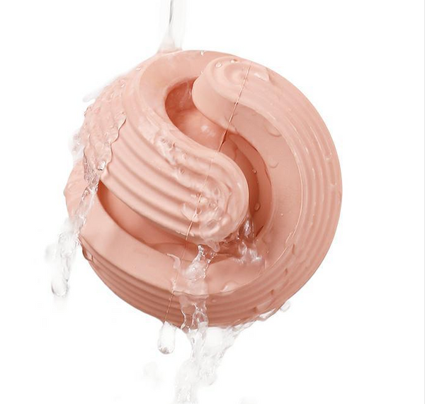 Pink rubber dog molar teeth relief bouncy ball being rinsed with water, showing its textured surface. - Image 15
