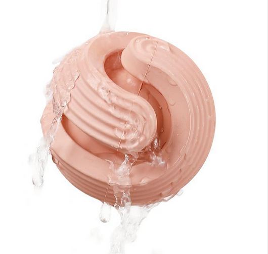Pink rubber dog molar teeth relief bouncy ball being rinsed with water, showing its textured surface. - Image 15