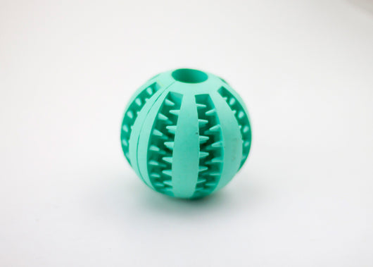 Bright green rubber pet toy ball with textured spikes and ridges for dental cleaning and food dispensing. - Image 9