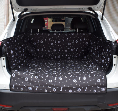 Blue waterproof pet car mat with white paw print and bone patterns installed in the trunk of a white SUV. - Image 3