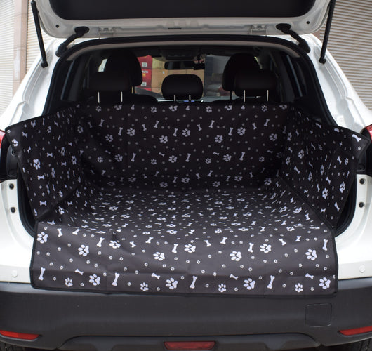 Blue waterproof pet car mat with white paw print and bone patterns installed in the trunk of a white SUV. - Image 3