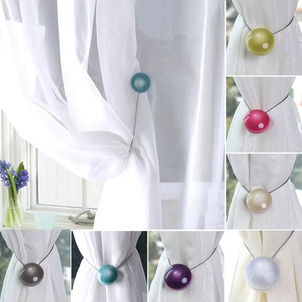 Purple magnetic curtain tieback with a round buckle and a thin silver wire loop on a white background.