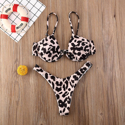 Black and white gingham bikini set with underwire bra top and high-cut thong bottom on a wooden surface.