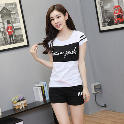 Young girl in a white short-sleeve t-shirt with a black stripe and black shorts, wearing a black cap. - Image 10