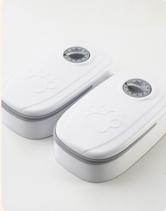White automatic pet feeder with a pink timer dial and an embossed paw print on the lid. - Image 9