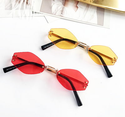 Retro oval vintage sunglasses with orange hexagonal lenses and gold-tone metal temples, held by a hand. - Image 3
