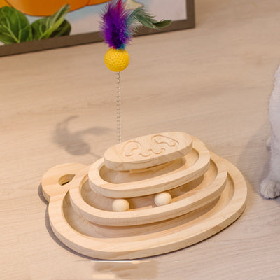 White cat playing with a wooden multi-level track toy featuring a spring-mounted yellow feather ball and a green catnip ball. - Image 13