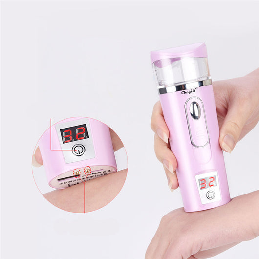 White and rose gold nano spray water meter with a clear tank, digital display, and power button.