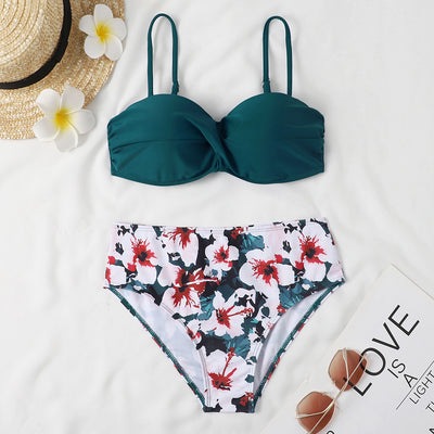 Teal twisted bandeau bikini top with tropical leaf print high-waisted bottoms on a model wearing a white shirt. - Image 10