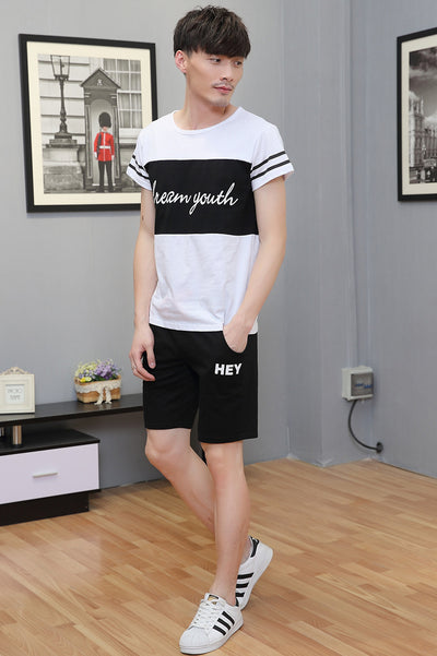 Young girl in a white short-sleeve t-shirt with a black stripe and black shorts, wearing a black cap. - Image 9