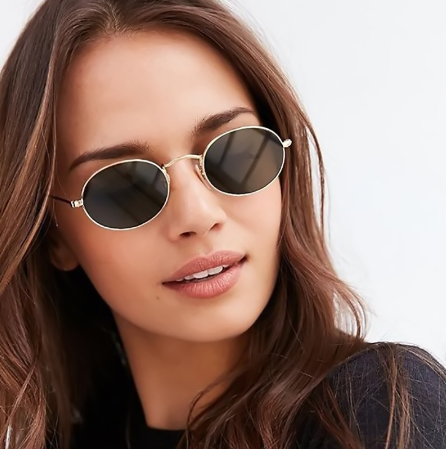 Gold-framed oval sunglasses with black mirror lenses and black temple tips, shown at an angle.