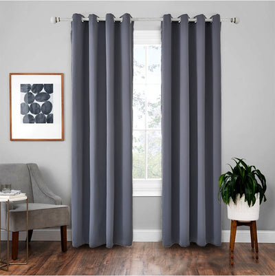 Light gray polyester blackout curtains with grommet tops hanging on a white rod in a modern living room. - Image 9