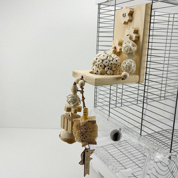 Natural ricepaperplant pith ball gnawing toy for parrots, featuring a braided top, wooden star, and 'short hair girl' design.