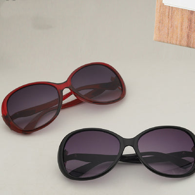 Brown oversized butterfly sunglasses with gradient lenses and a silver-tone floral accent on the temple.